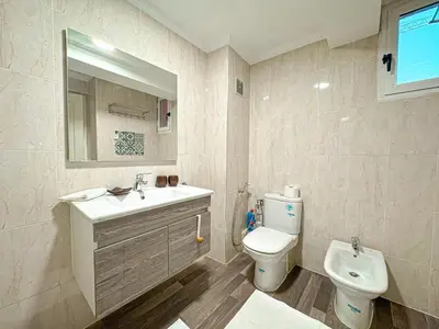 a bathroom with a sink and a toilet at Duplex Majorelle avec Jardin et Parking in Marrakech