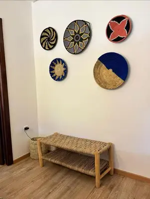 a room with plates on the wall and a bench at Green in majorelle in Marrakech