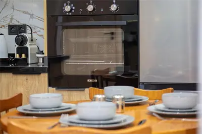 a kitchen with a table with plates and a microwave at Chic & comfort in the heart of Marrakech train station in Marrakech