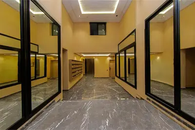 an empty hallway in a building with large windows at Chic & comfort in the heart of Marrakech train station in Marrakech