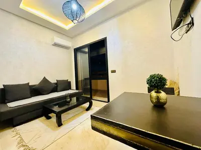 a living room with a couch and a table at Chic & comfort in the heart of Marrakech train station in Marrakech