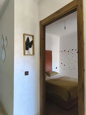 a bedroom with a bed with a glass door leading to it at Chic & comfort in the heart of Marrakech train station in Marrakech