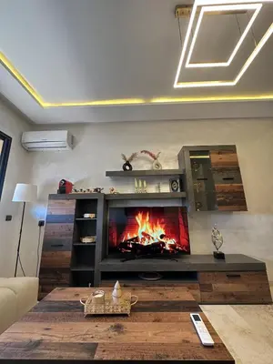 a living room with a fireplace and a couch at Amazing well located appartement centre of marrakech near medina in Marrakech