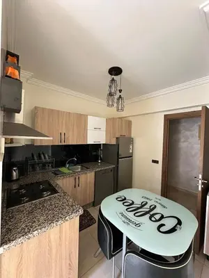 a kitchen with a table in the middle of it at Amazing well located appartement centre of marrakech near medina in Marrakech