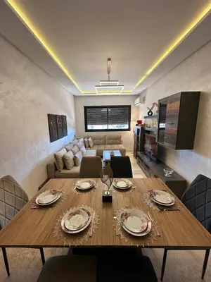 a living room with a table and a couch at Amazing well located appartement centre of marrakech near medina in Marrakech