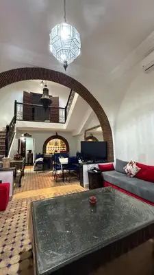 a living room with a couch and a table at Riad Medina Palmeraie in Marrakech