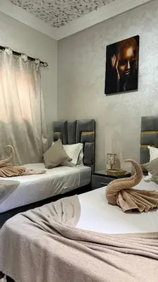 two beds sitting next to each other in a room at Riad Medina Palmeraie in Marrakech