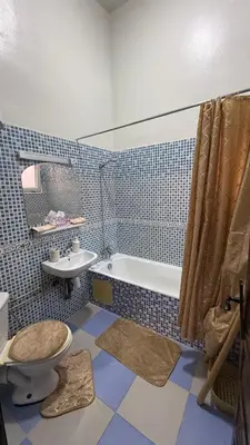 a bathroom with a tub and a toilet and a sink at Riad Medina Palmeraie in Marrakech