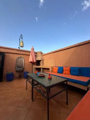 a patio with a couch and a table at Riad Medina Palmeraie in Marrakech