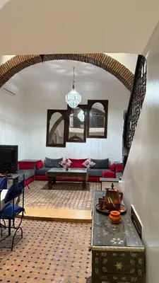 a living room with a couch and a table at Riad Medina Palmeraie in Marrakech