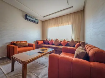 a living room with two couches and a table at Modern & cozy 2 bedroom apartment in Marrakech