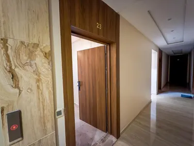 a hallway with a wooden door in a building at Modern & cozy 2 bedroom apartment in Marrakech
