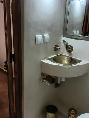 a bathroom with a sink and a mirror at Riad Le Bijou de Zahra Marrakech Kasbah in Marrakech