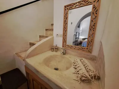 a bathroom with a sink with a mirror at Dar Kleta in Marrakech