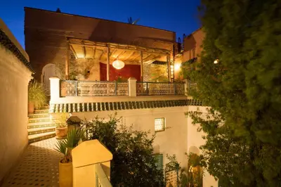 a building with a balcony with lights on it at Dar Kleta in Marrakech