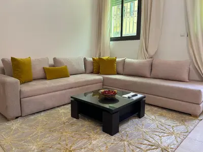 a living room with a couch and a coffee table at Appartements du luxe in Marrakech