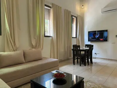 a living room with a couch and a table at Appartements du luxe in Marrakech