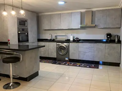 a kitchen with a washing machine in the middle at Appartements du luxe in Marrakech
