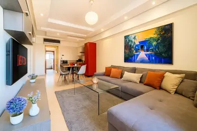 a living room with a couch and a table at Cocon de Guéliz - Central & balcon in Marrakech