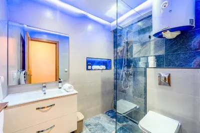 a bathroom with a shower and a sink and a toilet at Cocon de Guéliz - Central & balcon in Marrakech