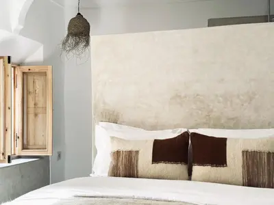 a bedroom with a white bed with two pillows at Dar Chiba Medina in Marrakech
