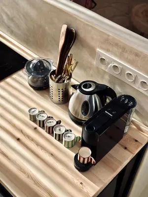 a wooden counter top with a tea kettle and utensils at Dar Chiba Medina in Marrakech