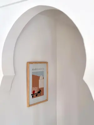 an archway in a white room with a picture on the wall at Dar Chiba Medina in Marrakech