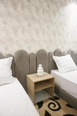 a bedroom with two beds and a side table at Central B1 Chic & Shock , hivernage city center in Marrakech
