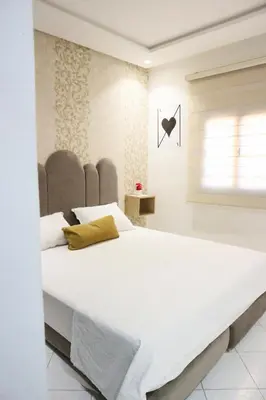a large white bed in a room with a window at Central B1 Chic & Shock , hivernage city center in Marrakech