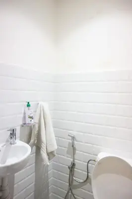 a white bathroom with a toilet and a sink at Central B1 Chic & Shock , hivernage city center in Marrakech