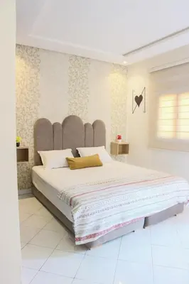 a bedroom with a large bed with a large headboard at Central B1 Chic & Shock , hivernage city center in Marrakech