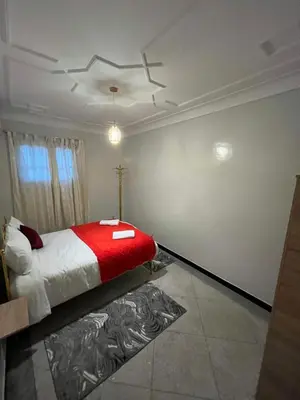 a bedroom with a bed with a red blanket at MarrakLuft in Marrakech