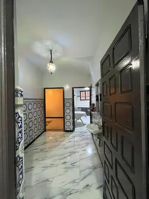 a hallway with a door and a tile floor at MarrakLuft in Marrakech