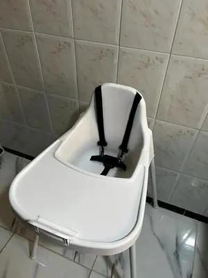 a white chair with a black belt sitting in a room at MarrakLuft in Marrakech