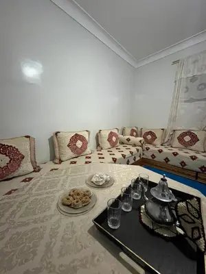 a living room with a couch and a table with food at MarrakLuft in Marrakech