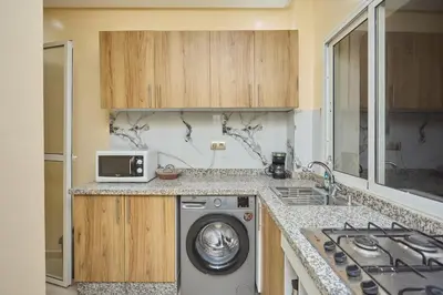 a kitchen with a washing machine on a counter at Appartement l'aéroport in Marrakech
