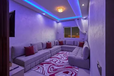 a purple living room with a couch and a rug at Appartement l'aéroport in Marrakech