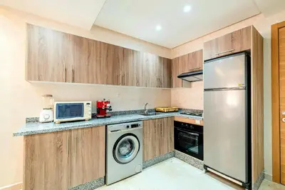 a kitchen with a refrigerator and a microwave at Comfort, ideal location in Guéliz Marrakech in Oulad Akkou