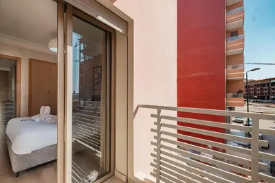 a room with a balcony with a window and a bed at Comfort, ideal location in Guéliz Marrakech in Oulad Akkou