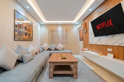a living room with a couch and a tv at Comfort, ideal location in Guéliz Marrakech in Oulad Akkou