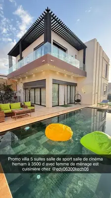 a house with a swimming pool in front of it at Villa luxueuse in Marrakech