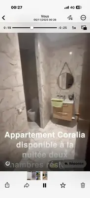 a screenshot of a bathroom with a picture of a sink and mirror at Bel appartement neuf in Marrakech