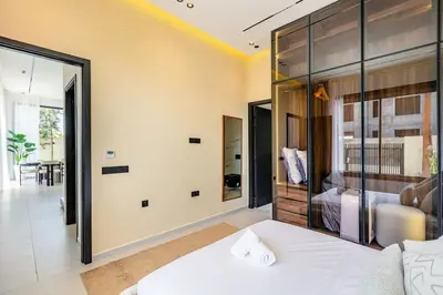 a bedroom with a bed and a glass wall at Luxury Villa, Design, Comfort, Heated Pool, Games in Marrakech