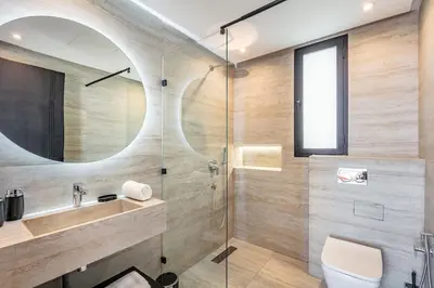a bathroom with a sink and a shower with a mirror at Luxury Villa, Design, Comfort, Heated Pool, Games in Marrakech