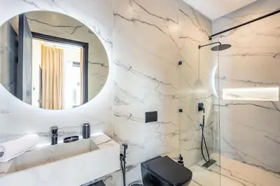 a bathroom with a shower and a mirror at Luxury Villa, Design, Comfort, Heated Pool, Games in Marrakech