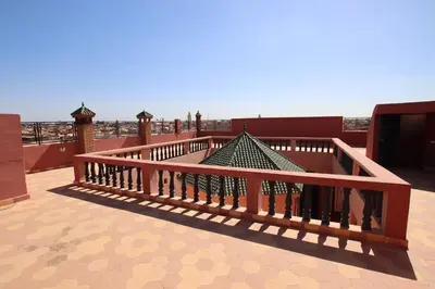 a railing on a balcony with a view of the ocean at Emerald palace in Marrakech