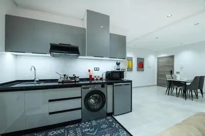 a kitchen with a washing machine in a room at The Pearl Loft, Marrakech Luxury Apartment in Marrakech