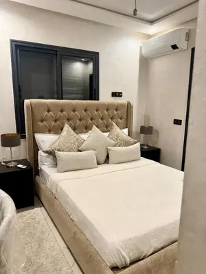 a bedroom with a large bed with white sheets and pillows at Modern charm in Marrakesh for a relaxing stay in Marrakech
