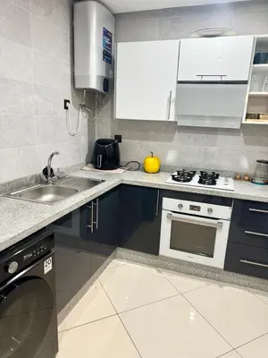a kitchen with a sink and a stove top oven at Modern charm in Marrakesh for a relaxing stay in Marrakech