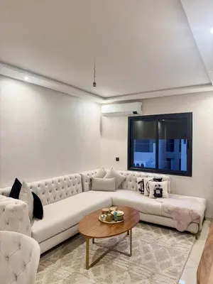 a living room with a white couch and a tv at Modern charm in Marrakesh for a relaxing stay in Marrakech